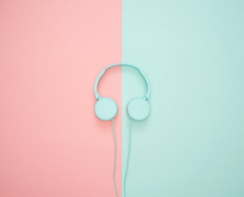 mint blue head phones on mint and pink background