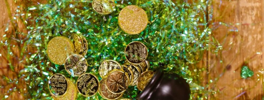 pot of gold coins spilt on its side on green packaging